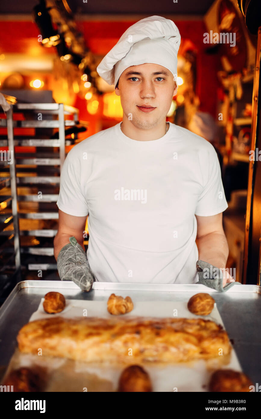 Chef holds baking sheet with fresh cooked strudel Stock Photo - Alamy