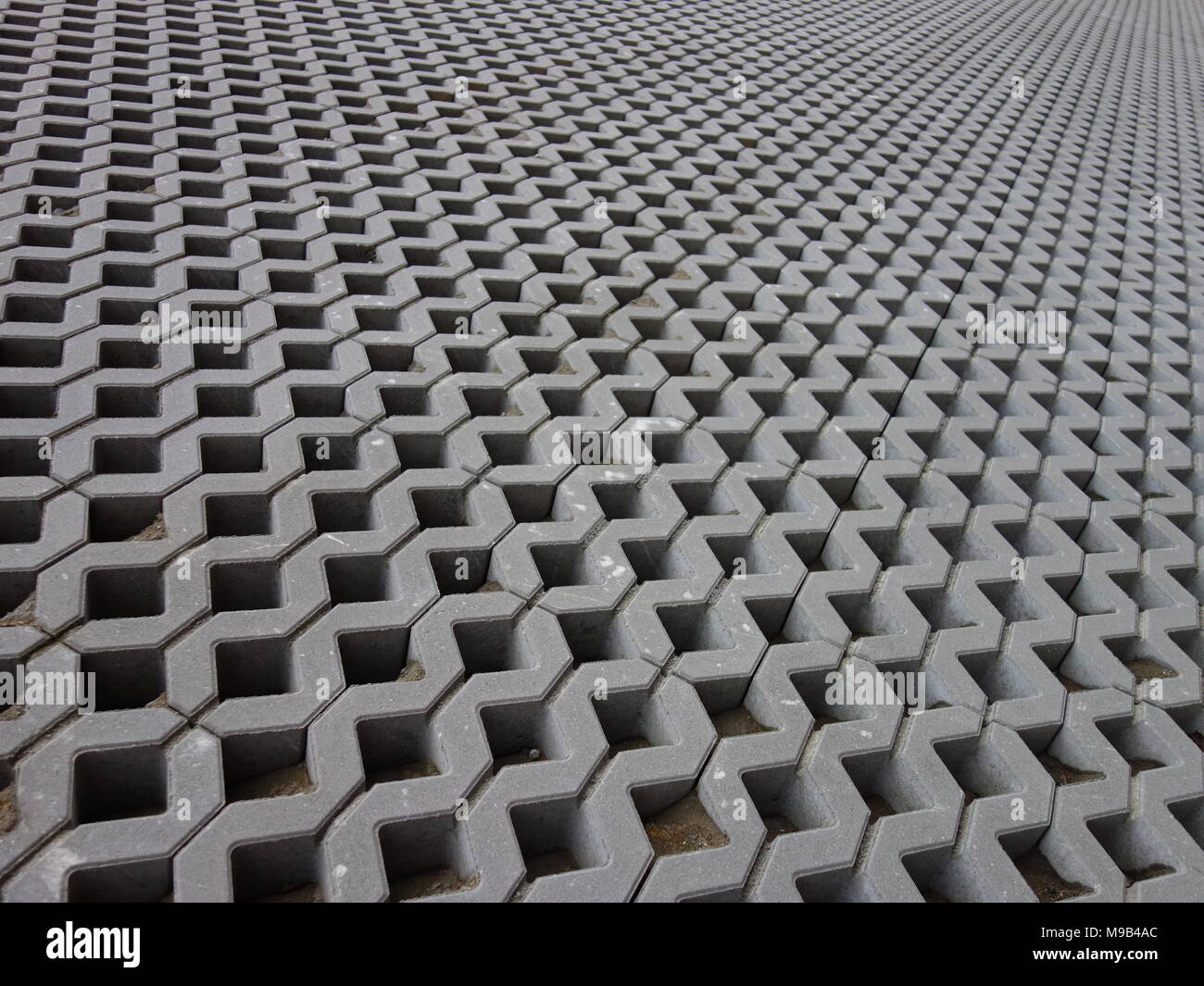 Concrete permeable grid pavers Stock Photo