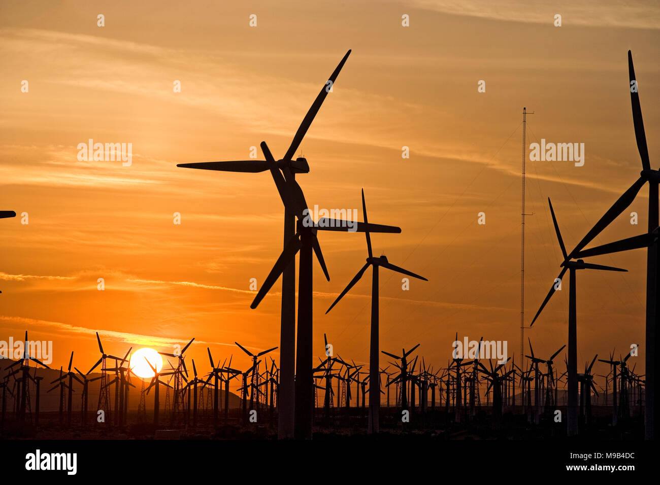 Power generating windmills in the Coachella valley of Southern California at sunset Stock Photo