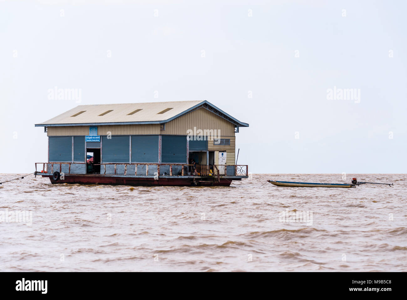 A floating fish processing factory on the Siem Reap River, Cambodia