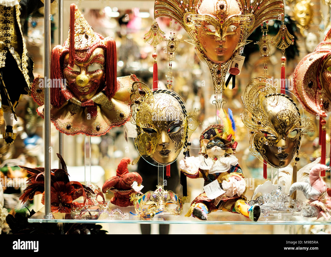 Ornate Venetian carnival masks in the window of a shop in San Marco, Venice Stock Photo