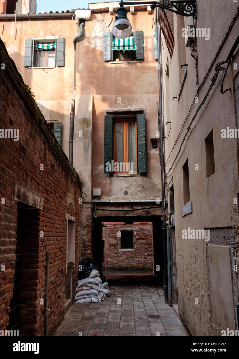 Leading to a canal with a view of Scuola Grande di San Rocco Stock Photo