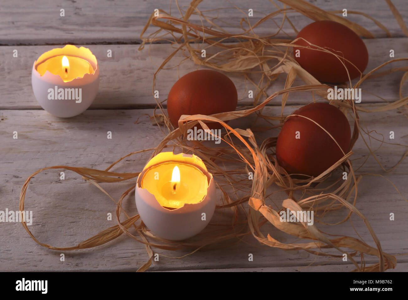 Rustic composition with candles and eggs. Happy easter. Selective focus. Stock Photo