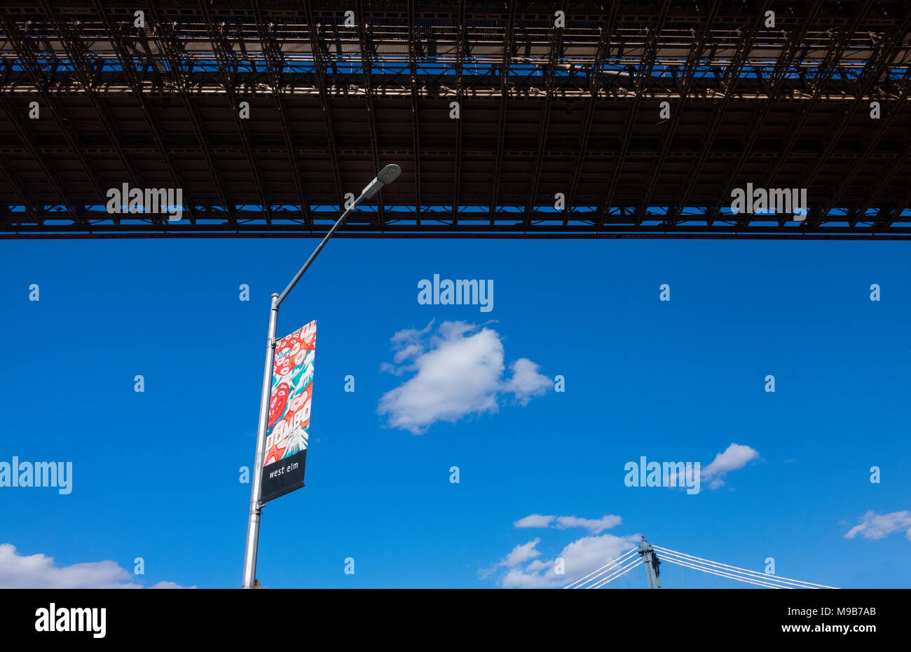 A West Elm sign under the Brooklyn Bridge Stock Photo