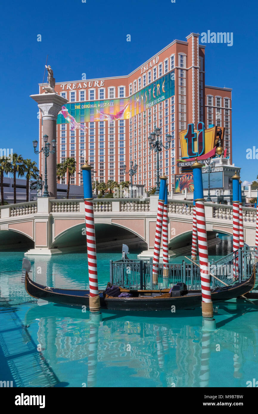 Gondola Ride and canal at The Venetian hotel in Las Vegas, with Treasure Island hotel in the background. Stock Photo