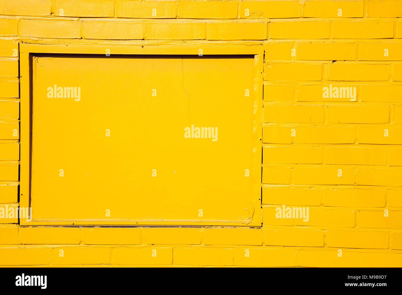 Yellow painted brick wall background Stock Photo