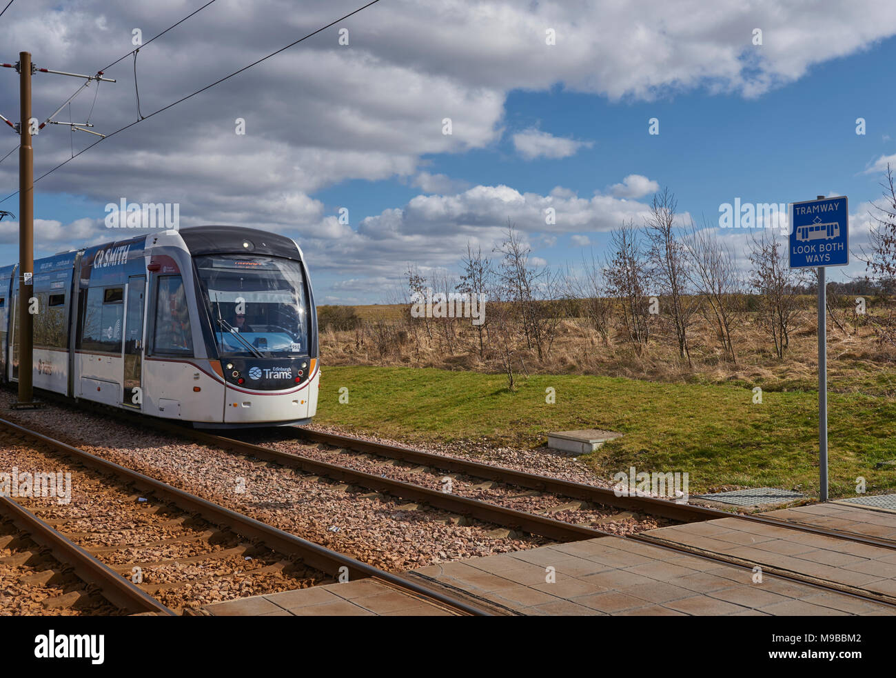 An Edinburgh Tram approaching a Station on the new Edinburgh Tram system, which runs from the City Centre to Edinburgh Airport. Stock Photo