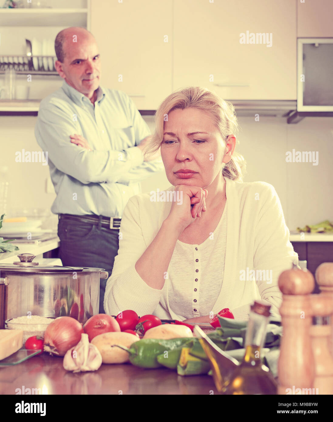 Sad senior man and mature woman during quarrel Stock Photo - Alamy