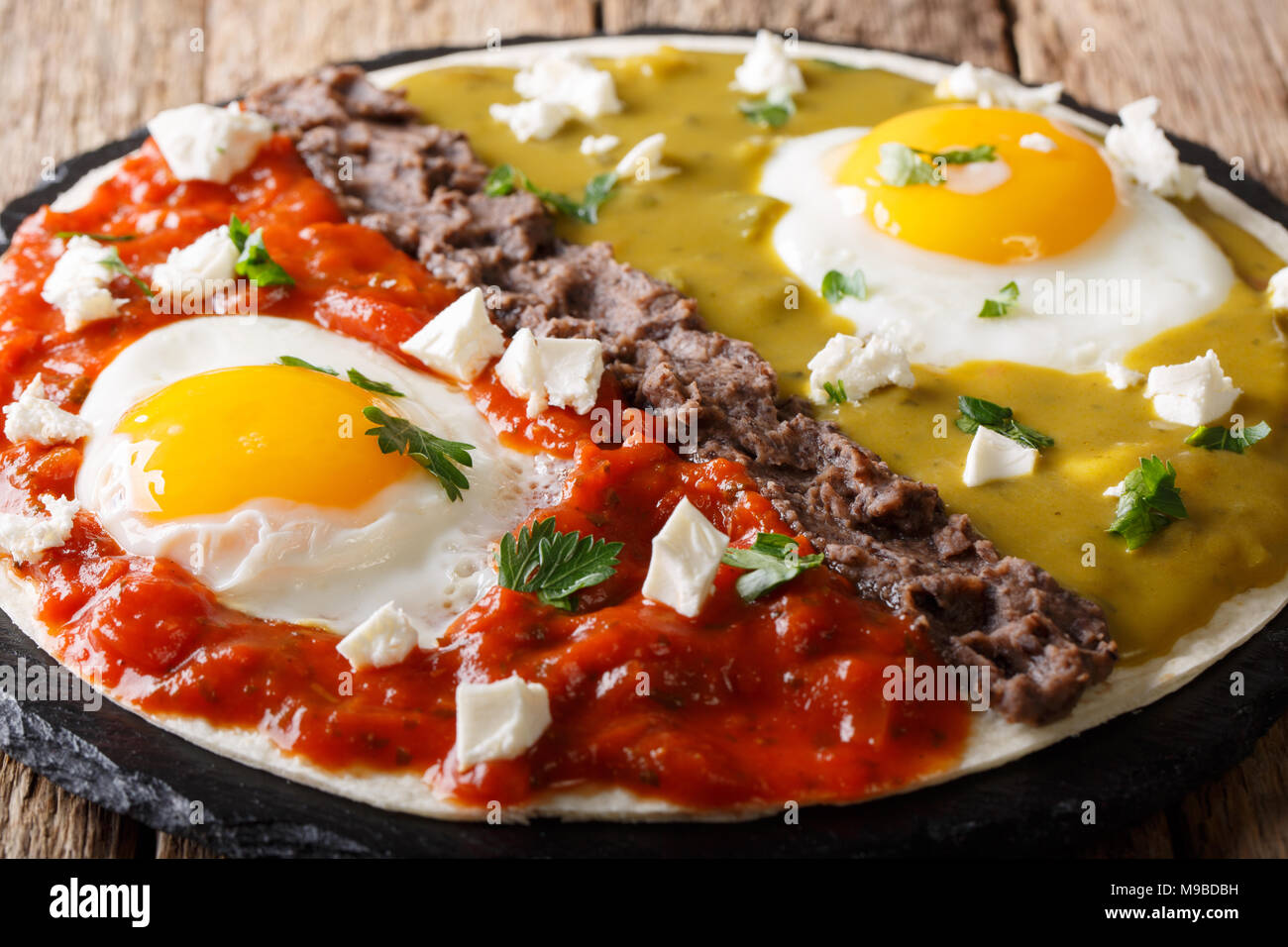 Delicious mexican dish eggs huevos divorciados with Frijoles refritos