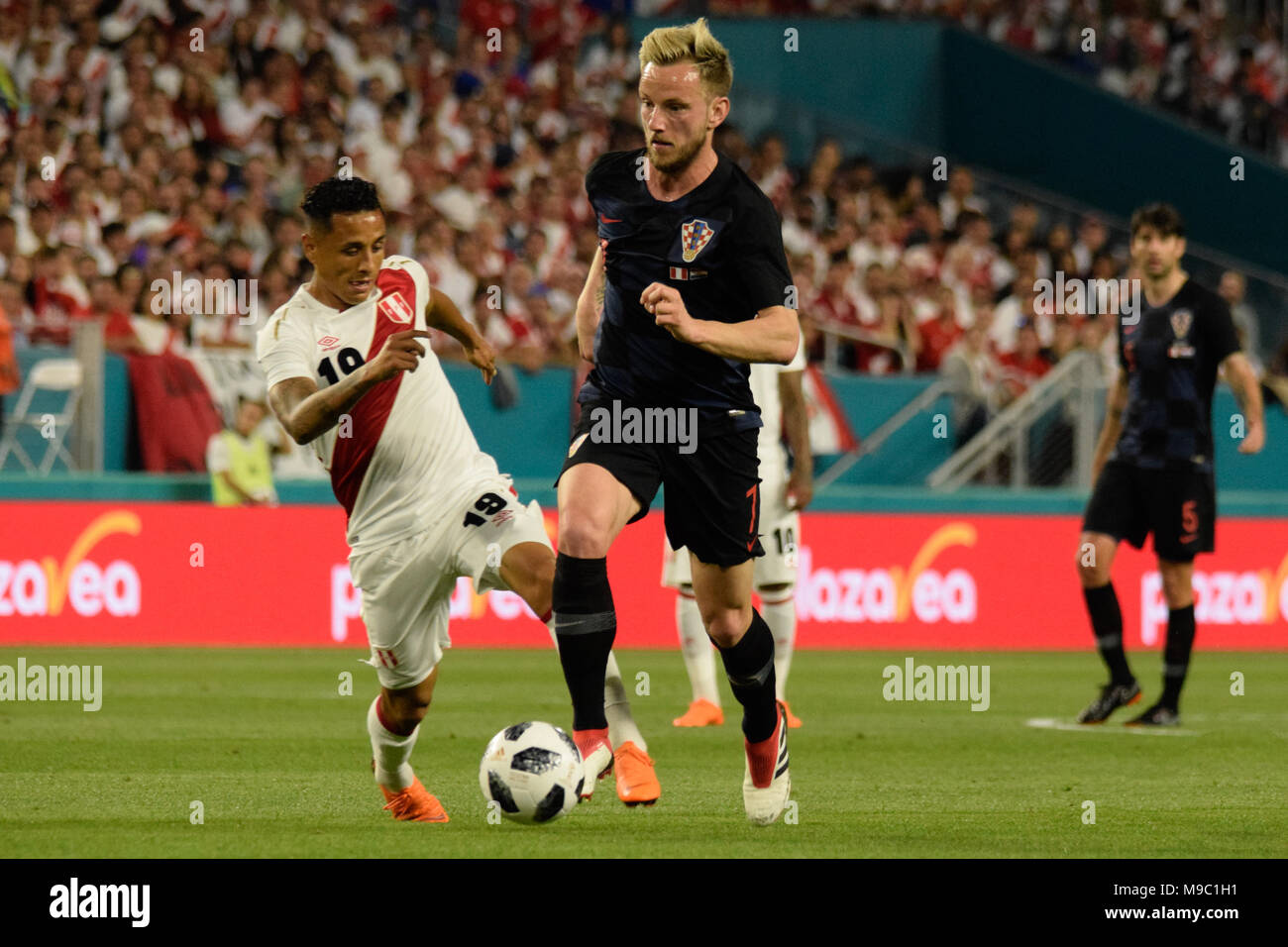 Miami, Florida, USA. 23rd Mar, 2018. Ivan Rakitic attacking in the Peruvian area followed by André Carrillo who seeks to stop him.The Croatian national football team played a friendly match against Peru on 23rd March 2018. Credit: Fernando Oduber/SOPA Images/ZUMA Wire/Alamy Live News Stock Photo