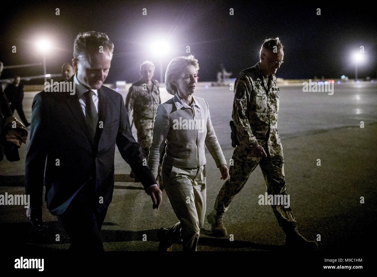 24 March 2018, Afghanistan, Mazar-e Sharif: German Defence Minister Ursula von der Leyen (CDU), being greeted by Bundeswehr (German Federal Armed Forces) general Wolf-Juergen Stahl (R) and general consul Robert Klinke (L) after her arrival to the Bundeswehr's camp. Photo: Michael Kappeler/dpa POOL/dpa Stock Photo