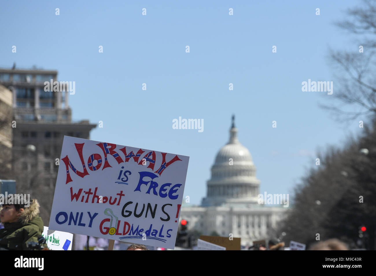 Washington, DC, USA. 24th Mar, 2018. A protester holds a sign on Pennsylvania Avenue with the US Capital in the background during the March for your Lives protest and march for gun control in the United States, held on Pennsylvania Avenue in Washington, DC. Credit: csm/Alamy Live News Stock Photo