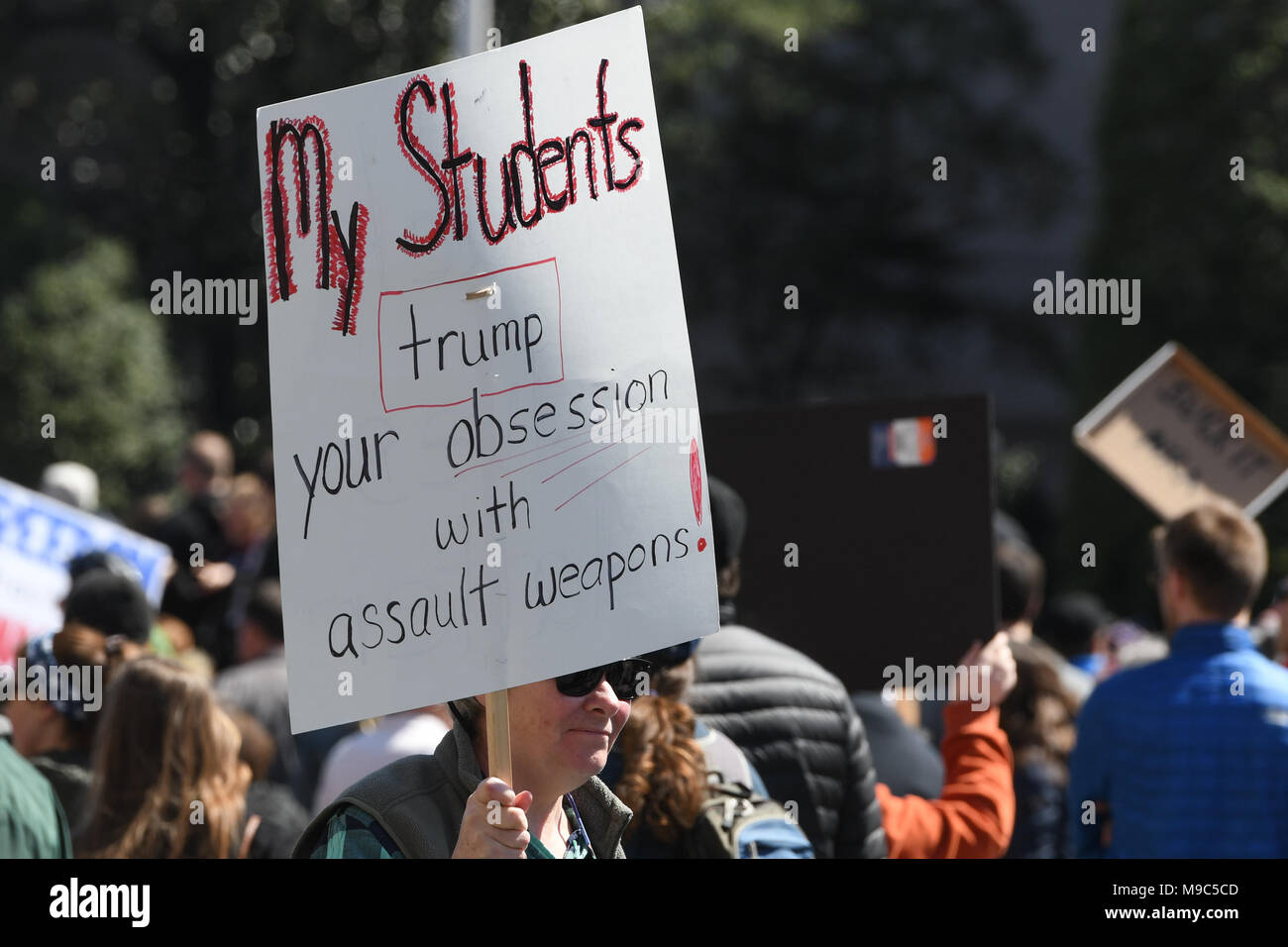 Washington, DC, USA. 24th Mar, 2018. A teacher marches with a sign during the March for your Lives protest and march for gun control in the United States, held on Pennsylvania Avenue in Washington, DC. Credit: csm/Alamy Live News Stock Photo