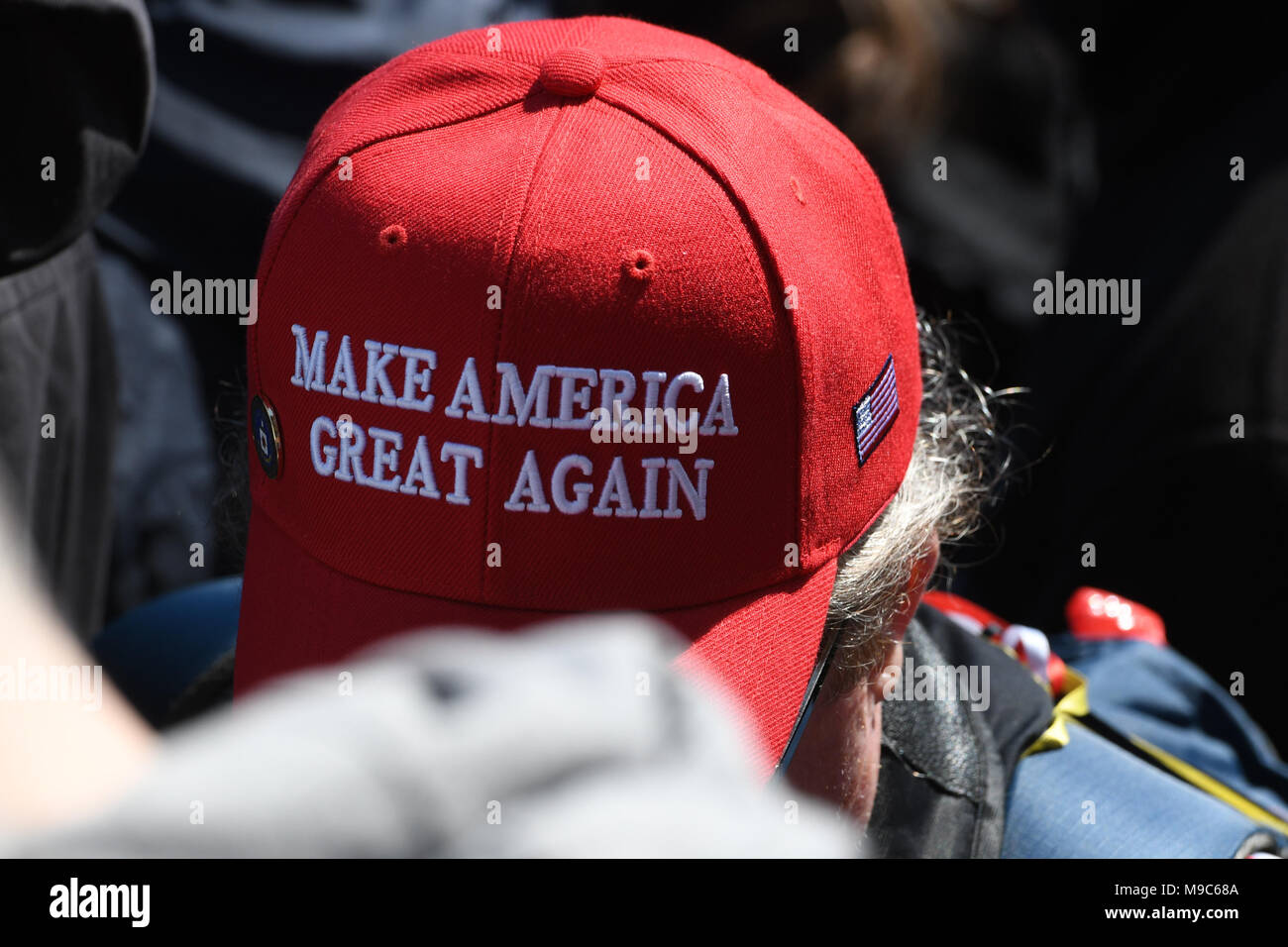 Washington, DC, USA. 24th Mar, 2018. A lone MAGA supporter walks with his head down through the crowd during the March for your Lives protest and march for gun control in the United States, held on Pennsylvania Avenue in Washington, DC. Credit: csm/Alamy Live News Stock Photo