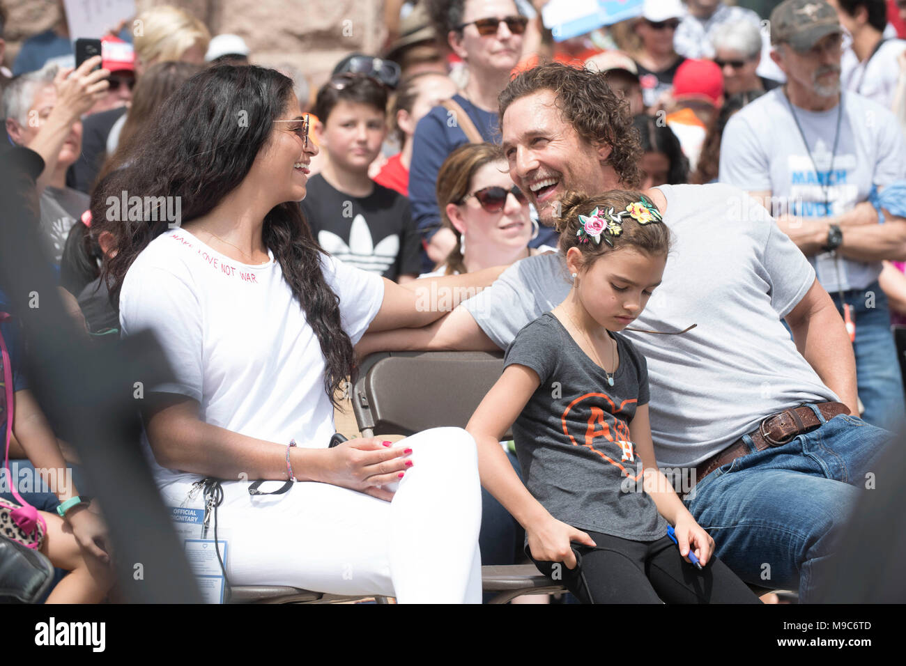 Actor Matthew McConaughey, with wife Camila Alves and daughter Vida, waits to speak to the nearly 10,000 marchers who converged at the Texas State Capitol at March For Our Lives protesting gun violence in the wake of school mass shootings including Parkland, FL in February 2018. Stock Photo