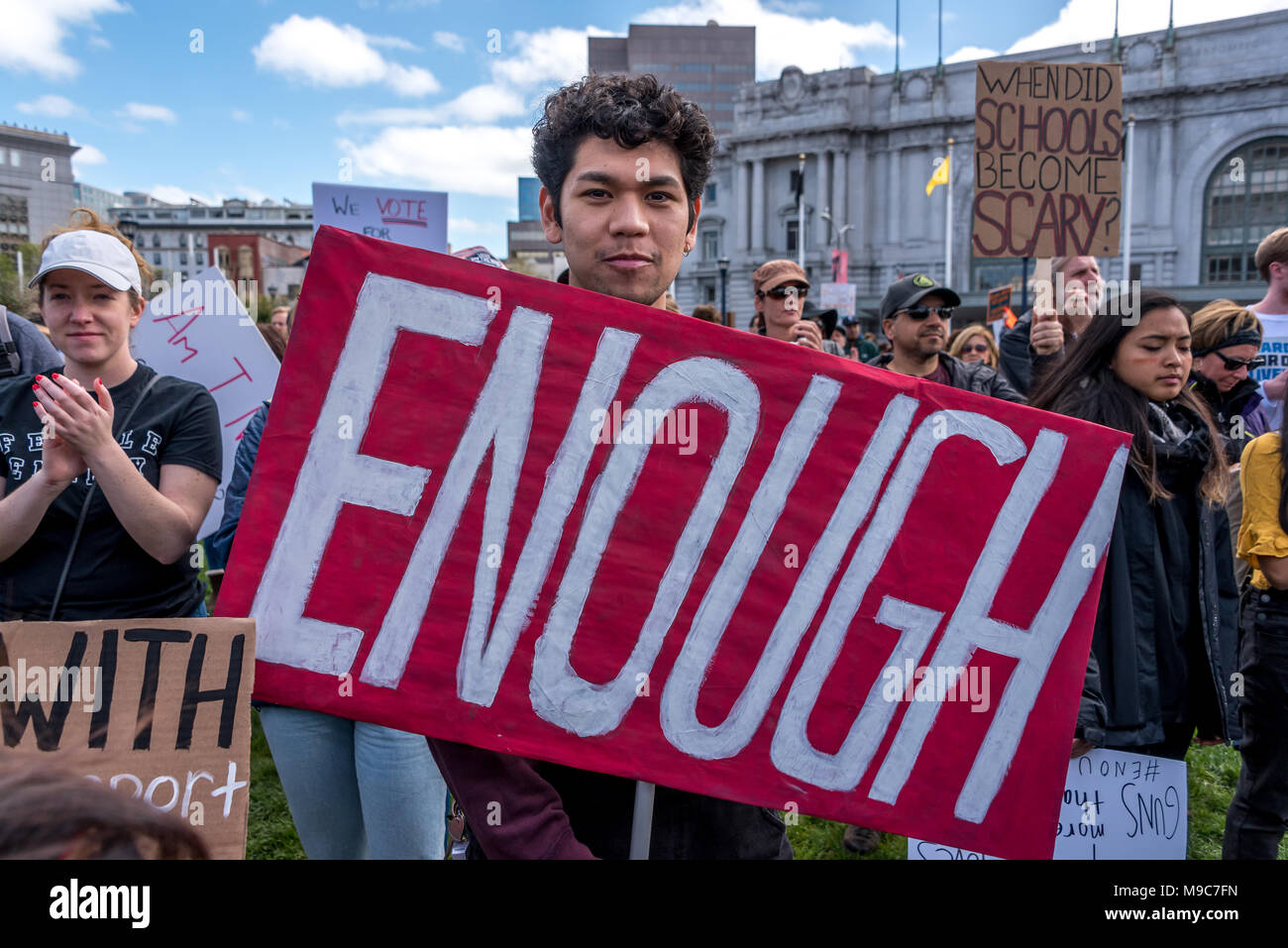 San Francisco, USA. 24th March, 2018. At the March for Our Lives rally and march to call for gun control and end gun violence, a boy teen student holds a sign reading Enough, the hashtag for the student movement. #Enough Shelly Rivoli/Alamy Live News Stock Photo
