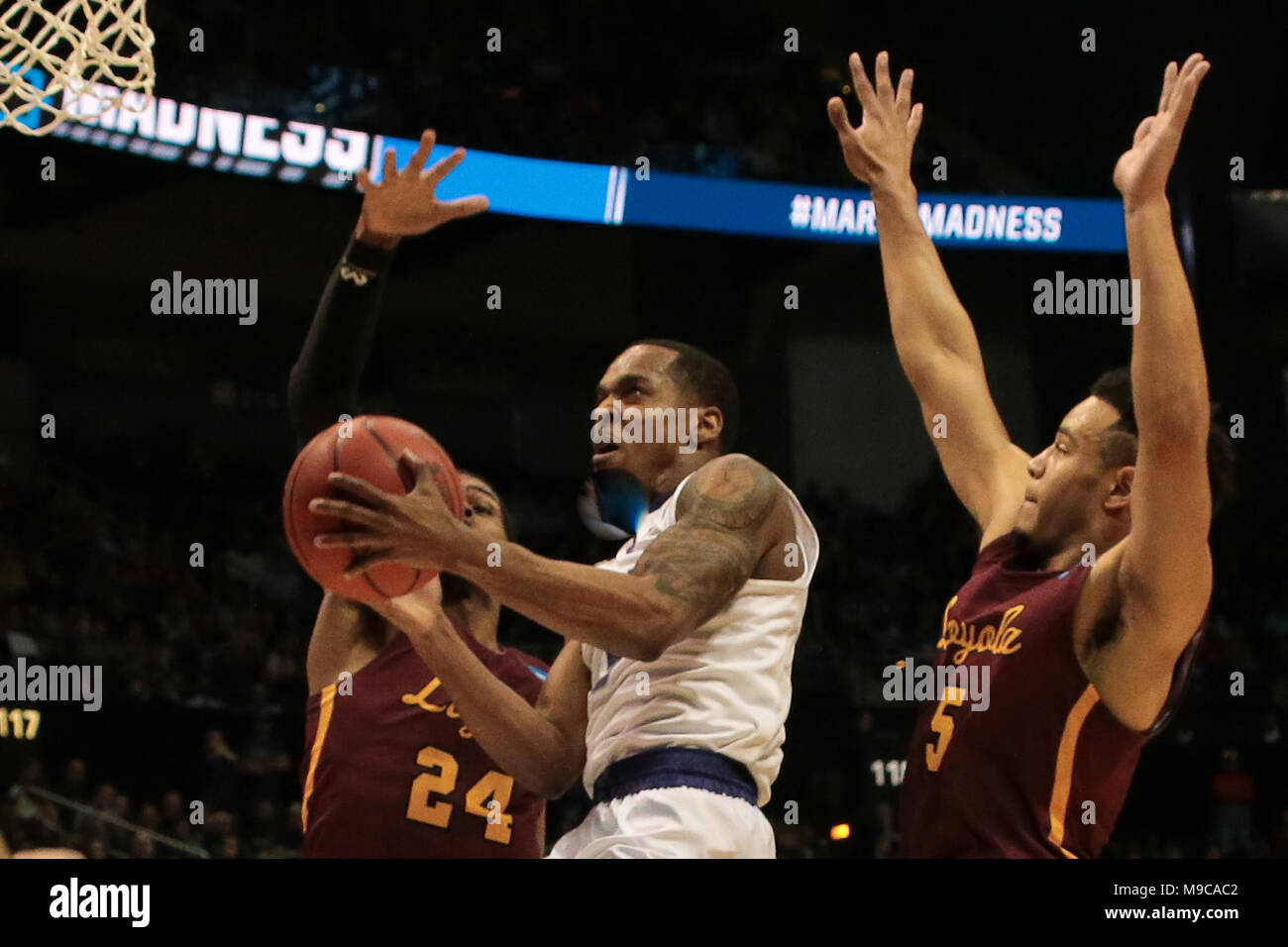 ATLANTA - MAR 24: Kansas State Wildcats guard Barry Brown Jr. (5) goes up for a shot as Loyola-Chicago Ramblers guard Marques Townes (5) and forward Aundrew Jackson (24) defend during the Elite 8 game at Philips Arena on March 24, 2018 in Atlanta, Georgia. Loyola-Chicago won 78-62 to advance to the Final Four. Stock Photo