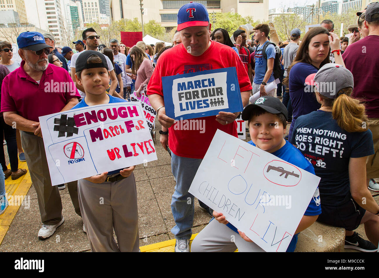 Dallas, Texas, USA. 24th Mar, 2018. Robert Pacheco (center) and his two sons Ethan, 8, left and Ryan, 7, right, protest current lack of gun legislation durng ther March for Our Lives event at Dallas City Hall on Saturday. Credit: Jaime Carrero/ZUMA Wire/ZUMAPRESS.com/Alamy Live News Stock Photo