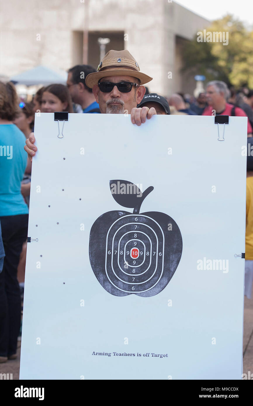 Dallas, Texas, USA. 24th Mar, 2018. Virgil Scott, a professor of Visual Communications at Texas AM in Commerce Texas holds a sign in solidarity with the students who organized the March for Our Lives event in front of Dallas City hall in downtown Dallas. Credit: Jaime Carrero/ZUMA Wire/ZUMAPRESS.com/Alamy Live News Stock Photo