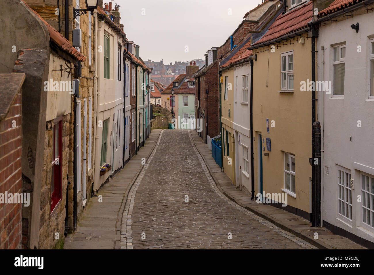 Whitby, North Yorkshire, England, UK - May 06, 2016: Narrow lane with houses Stock Photo