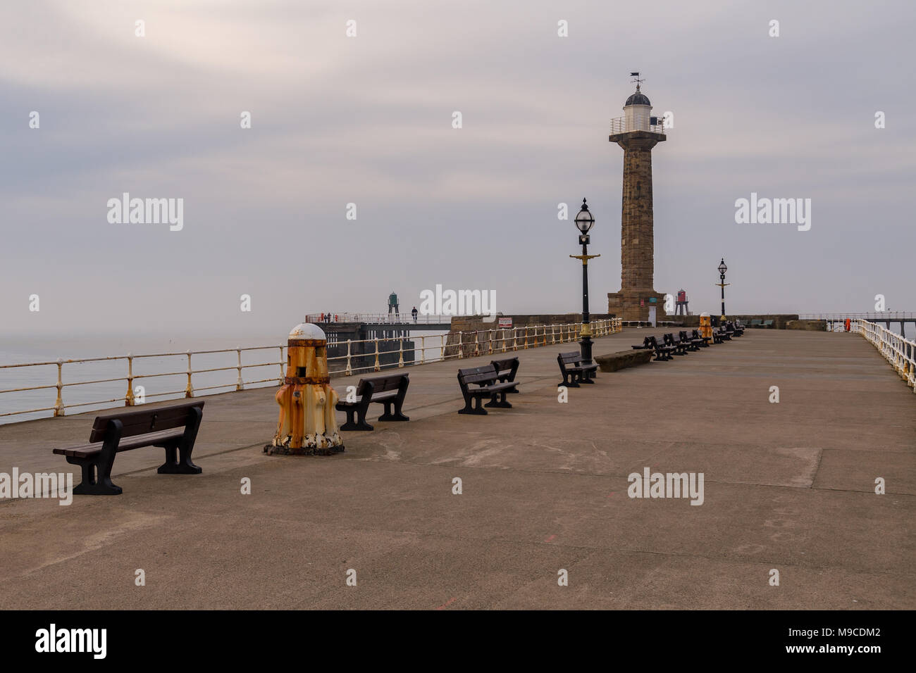 Whitby, North Yorkshire, England, UK - May 06, 2016: Evening clouds at the West Pier of Whitby harbour Stock Photo