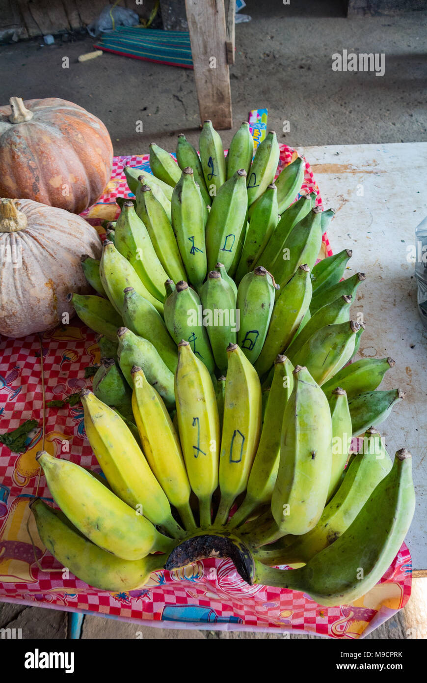 Green bananas at food market, Thailand Stock Photo