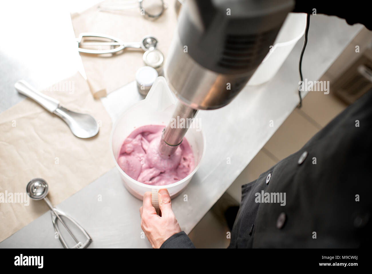 Mixing milk with berries for ice cream Stock Photo Alamy