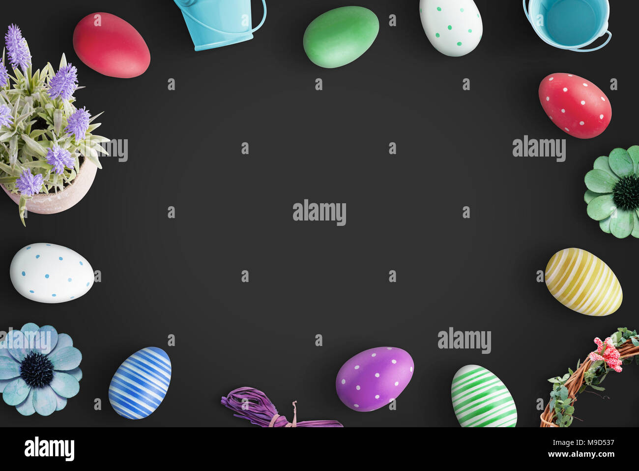 Easter background with colorful eggs on black background. Stock Photo