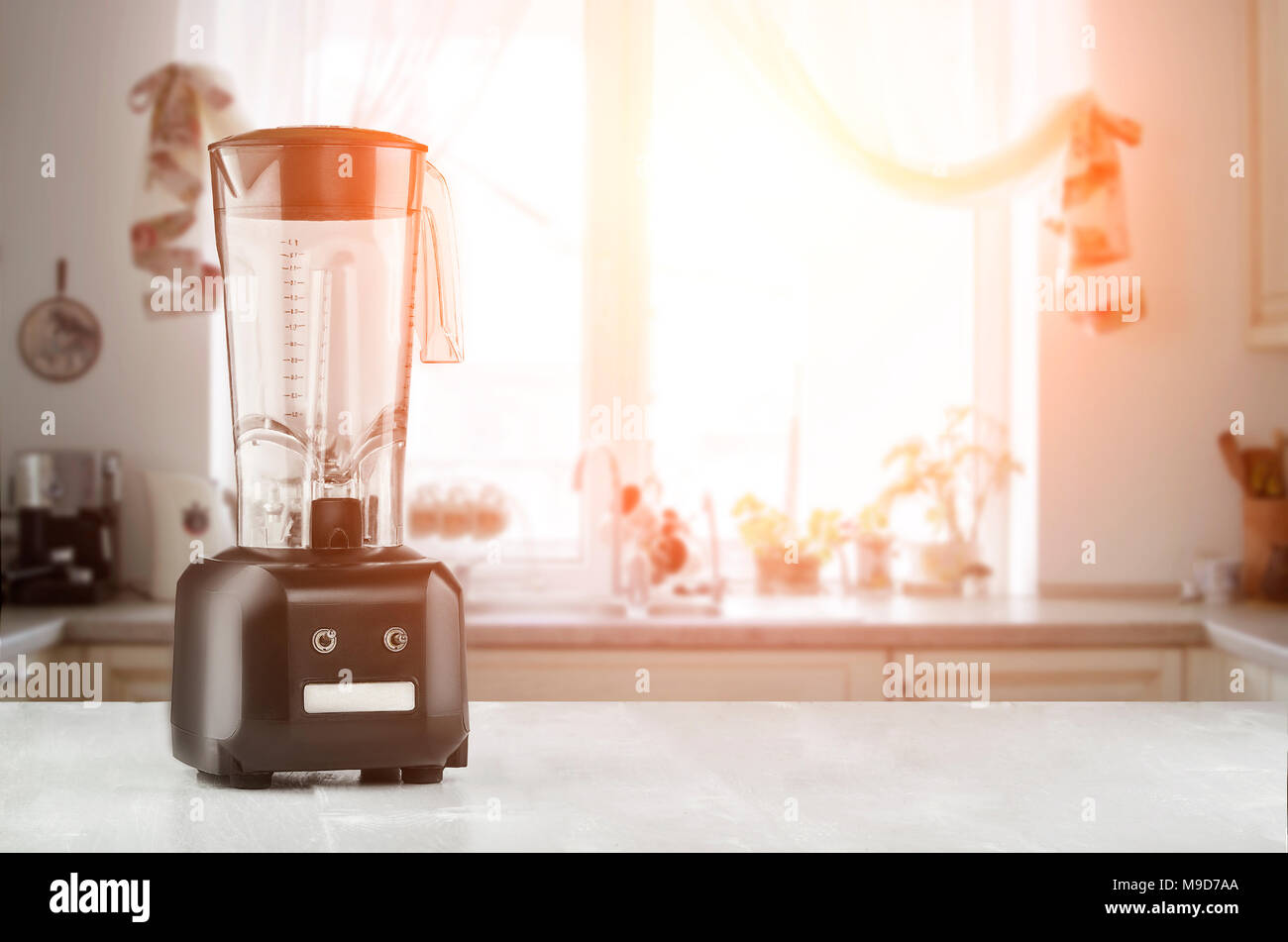 White kitchen machine and stand mixer on a wooden table in a bright design  apartment Stock Photo - Alamy