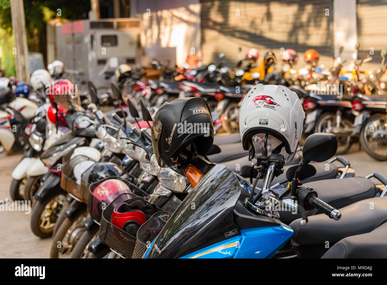 Scooters With Helmets Parked On A Street In Siem Reap Cambodia