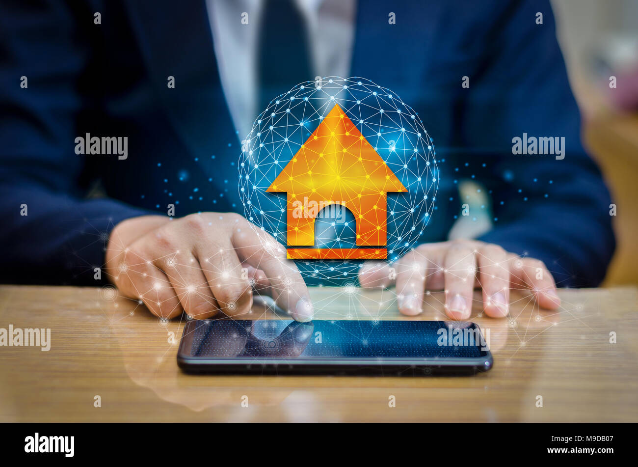 The house is in the hands of the business man  home icon or symbol Stock Photo