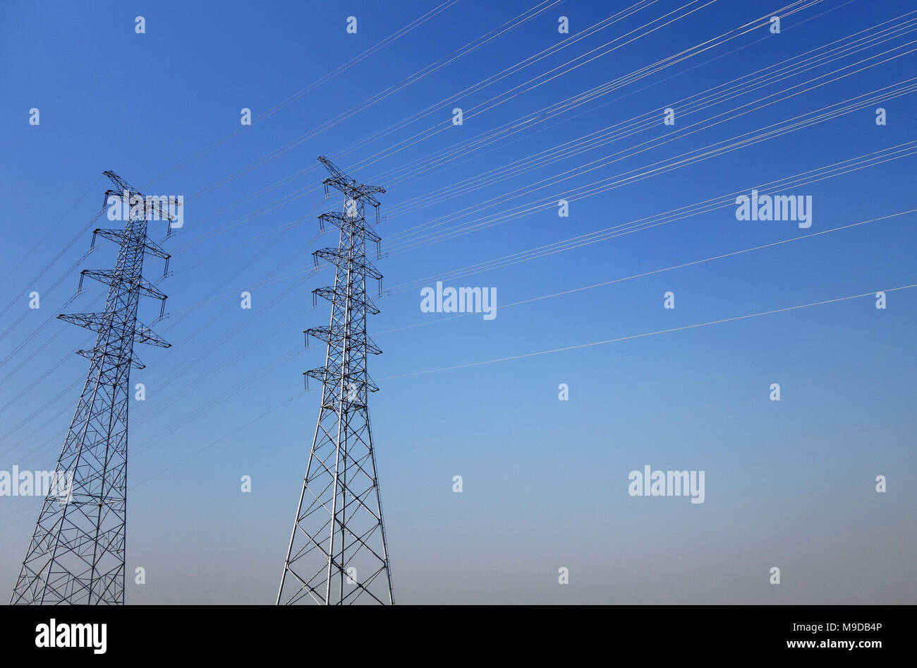 Electrical poles of high voltage in blue sky Stock Photo - Alamy