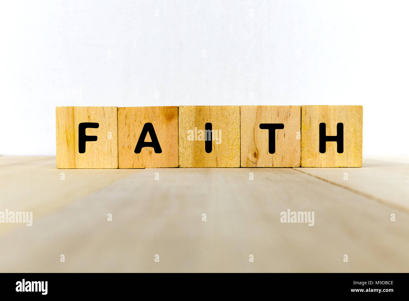 Faith word on wood block -religion concept Stock Photo