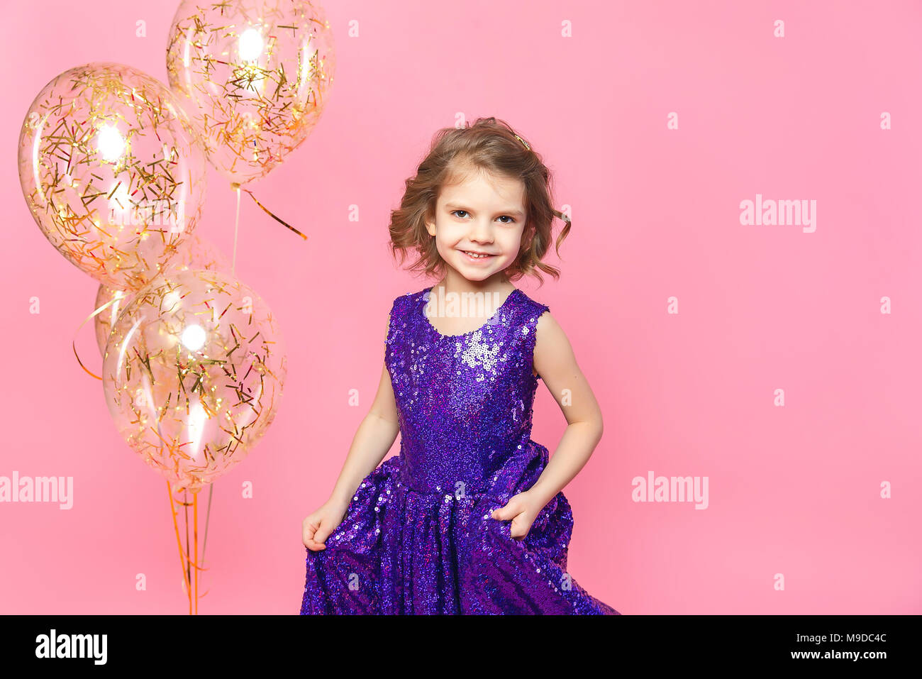 Festive little girl with balloons Stock Photo - Alamy
