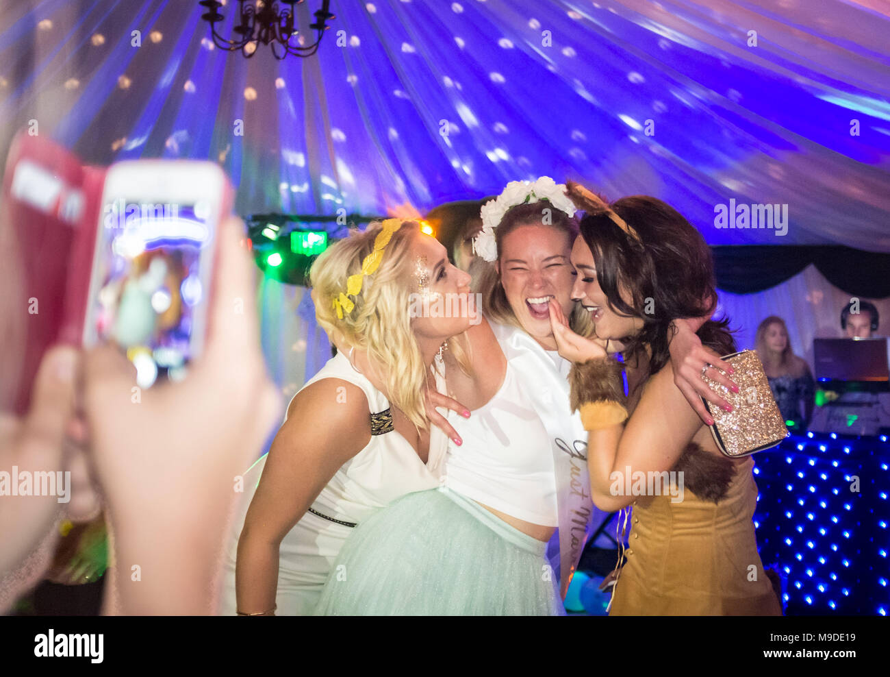 Girls having their photo taken whilst on night out Stock Photo