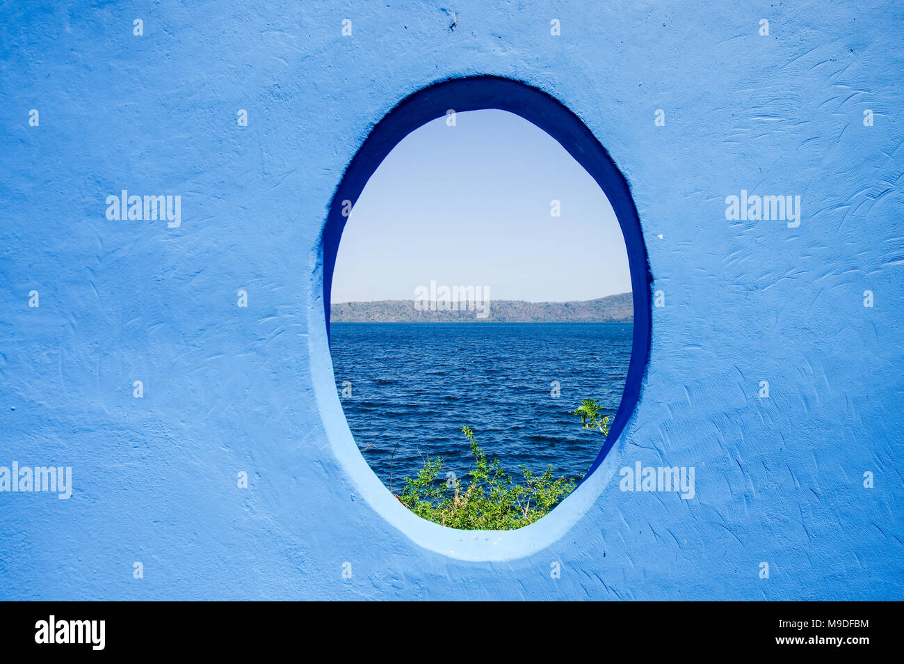 Rustic blue window overlooking Laguna de Apoyo lake in Nicaragua, Central America Stock Photo
