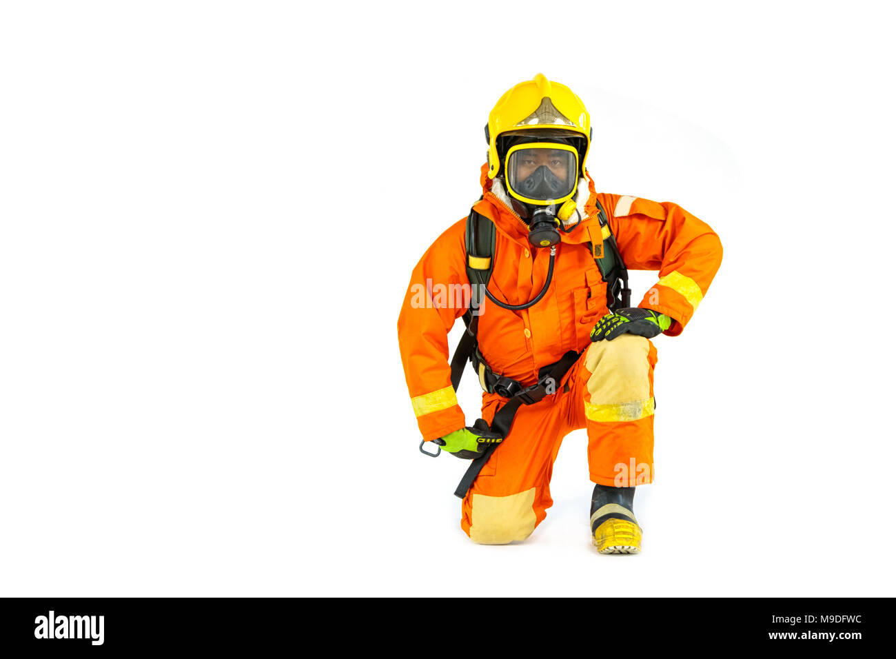 Firefighter in uniform and safety helmet standing full body length Stock Photo