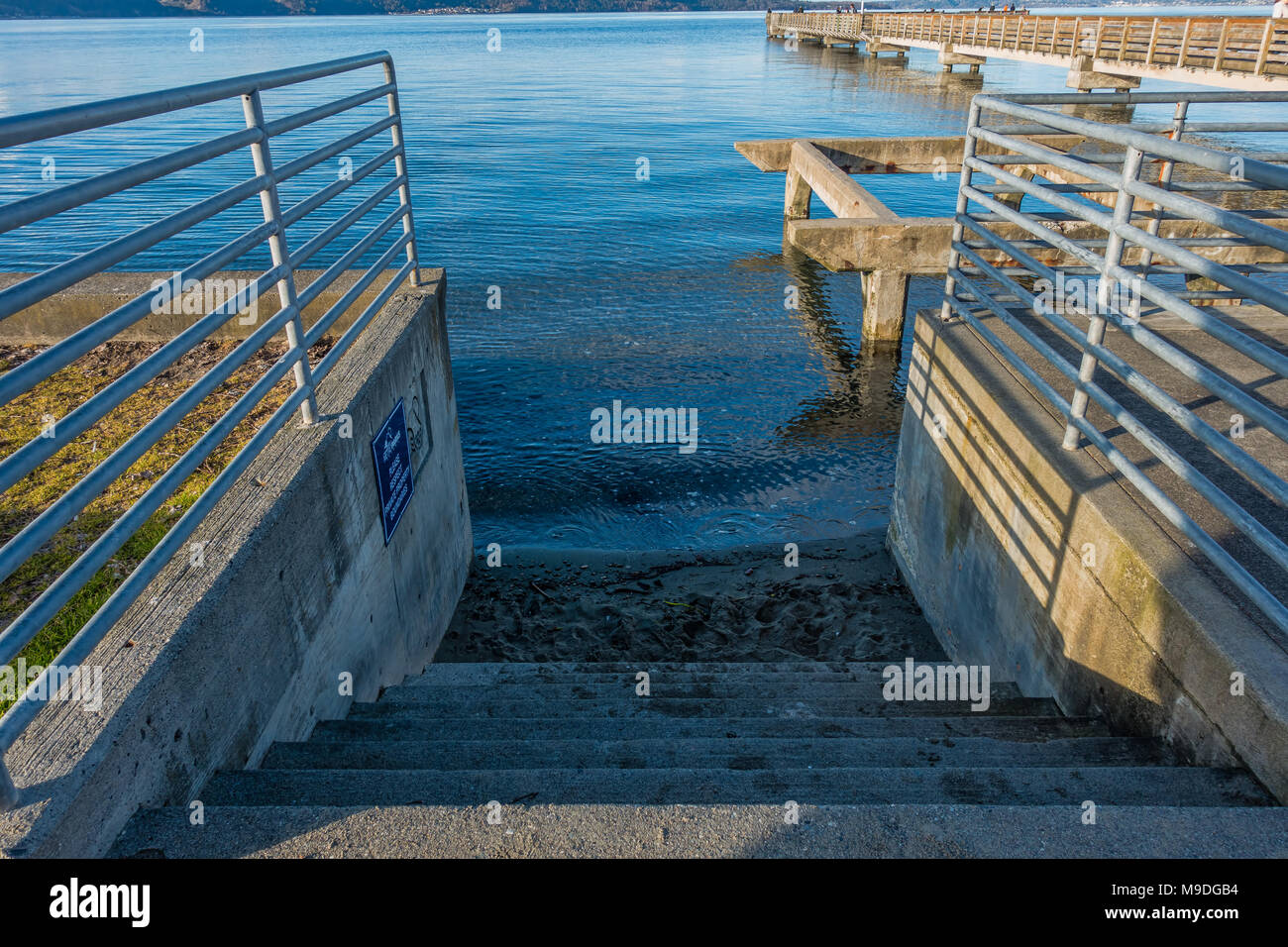 Cement steps lead into the sea at Dash Point, Washington. Stock Photo