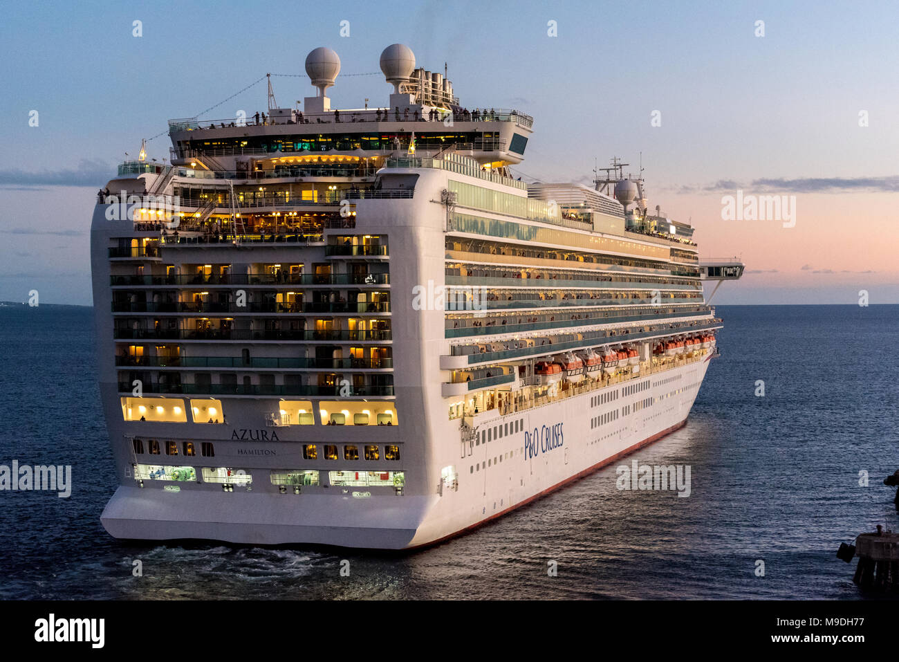 P&O Cruise Ship Azura leaving Basseterre on Saint Kitts as the sun goes down on a warm evening Stock Photo