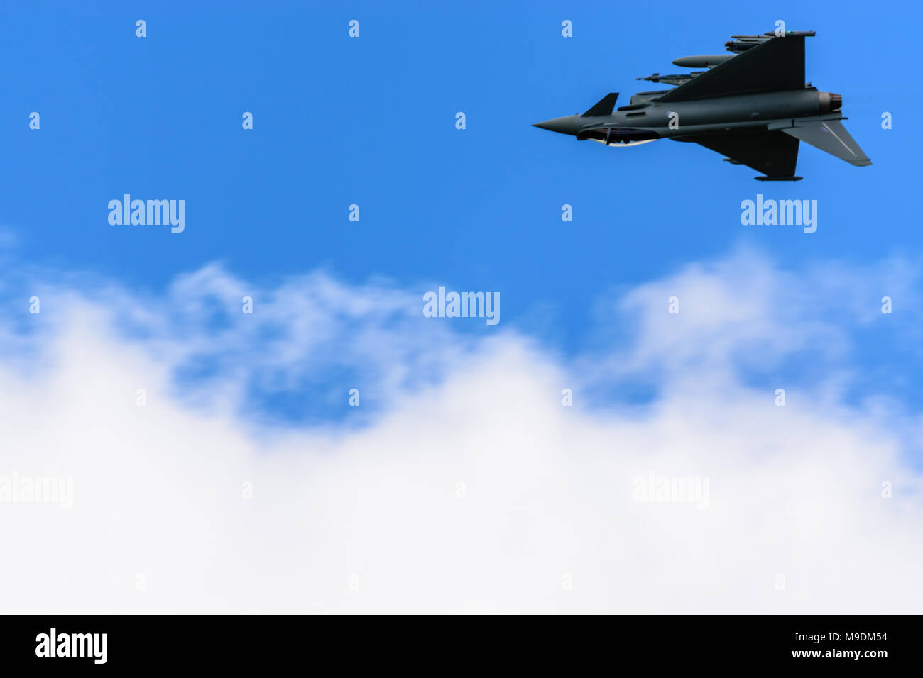 farnborough Airshow 2016: a Eurofighter Typhoon flies inverted above some clouds Stock Photo