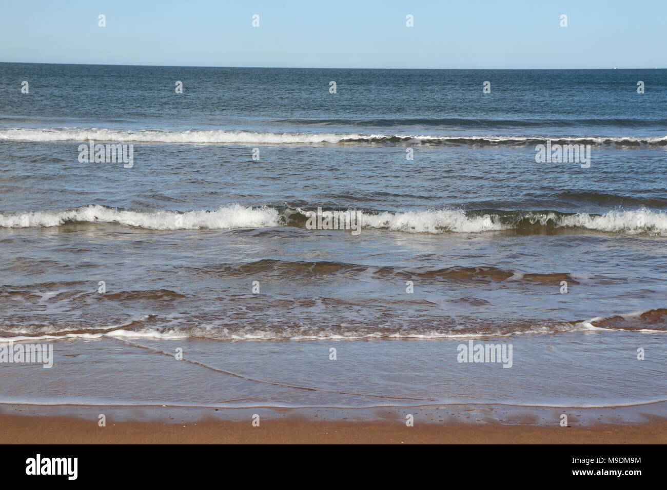 Blue sea waves arriving beach hi-res stock photography and images - Alamy