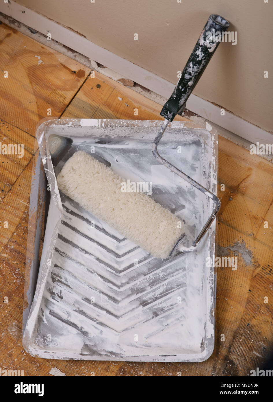 Painting supplies roller, tray liner in house under remodeling Stock