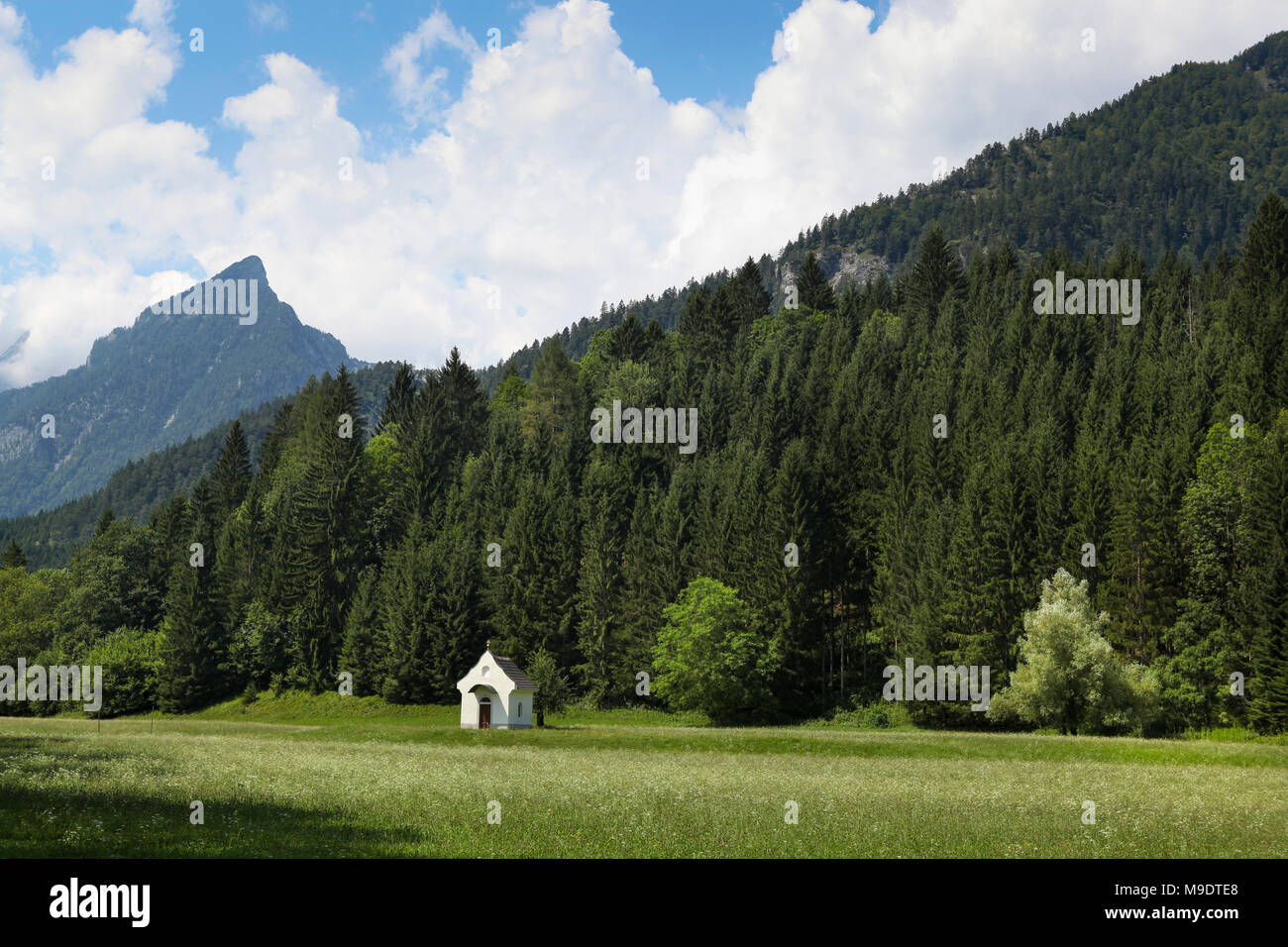 Small white chapel in a landscape with mountains, Austria Stock Photo