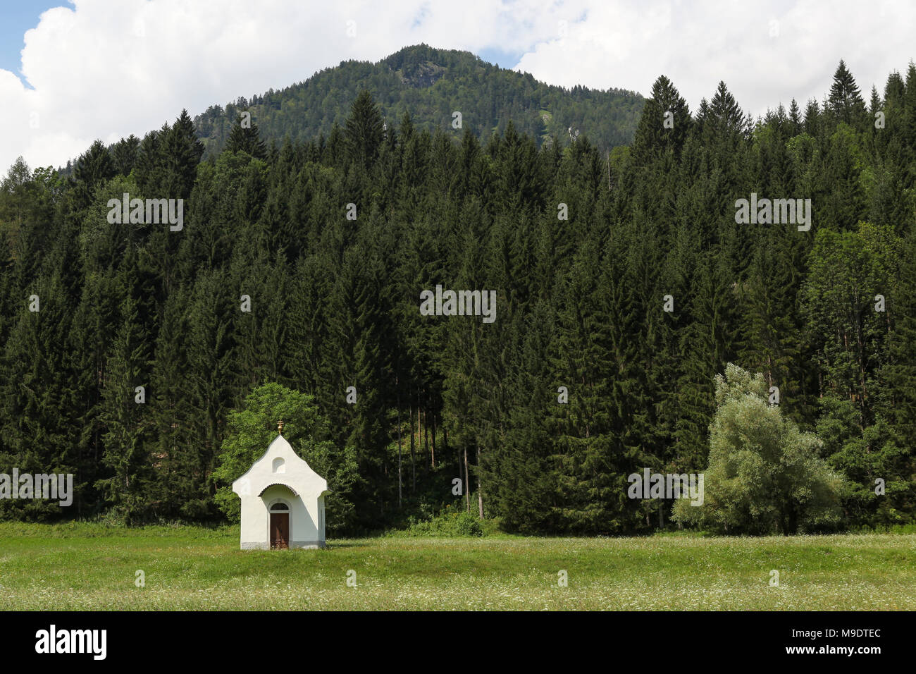 Small white chapel in a landscape with mountains, Austria Stock Photo