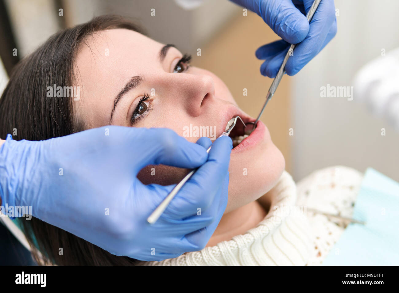 Examination of teeth in a patient sitting in a dental chair, close-up ...