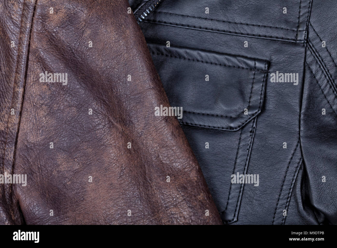 Leather jackets in brown and black colors background. Stock Photo