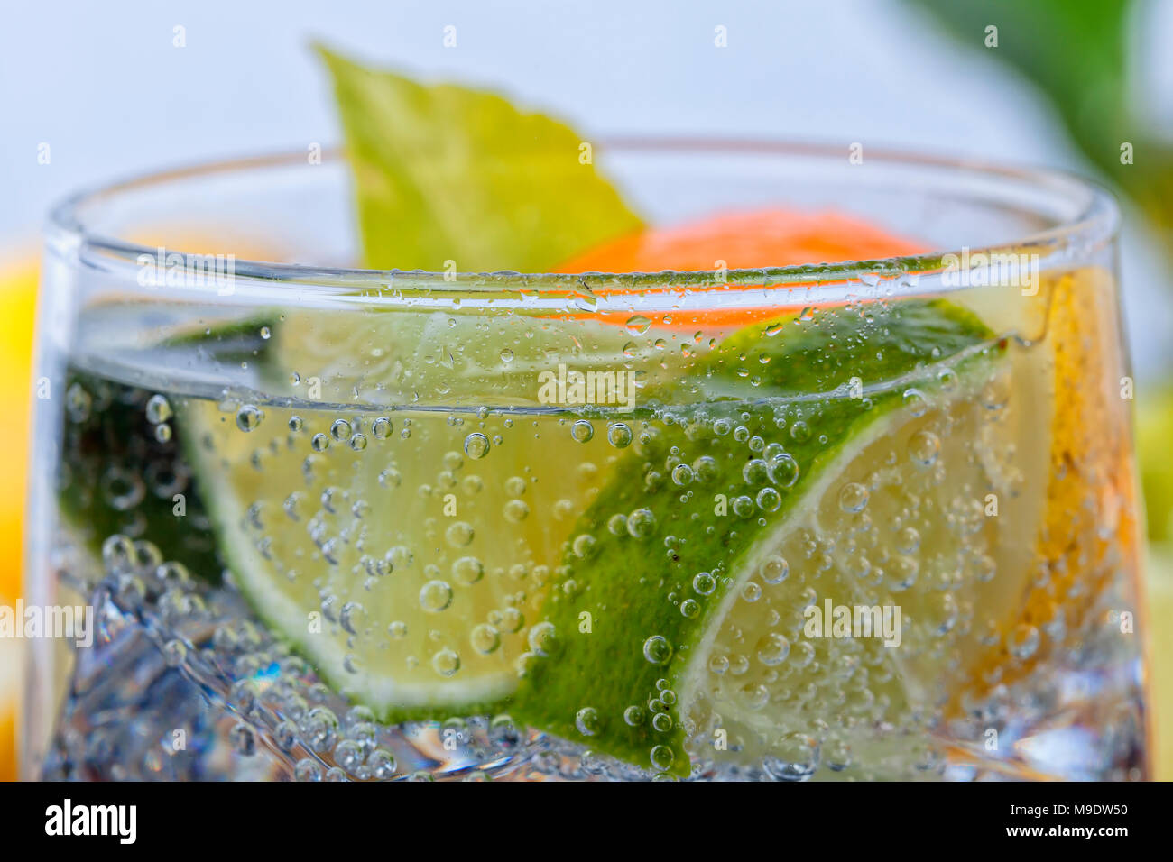 Homemade cocktail with citrus fruits in glass cup with transparent