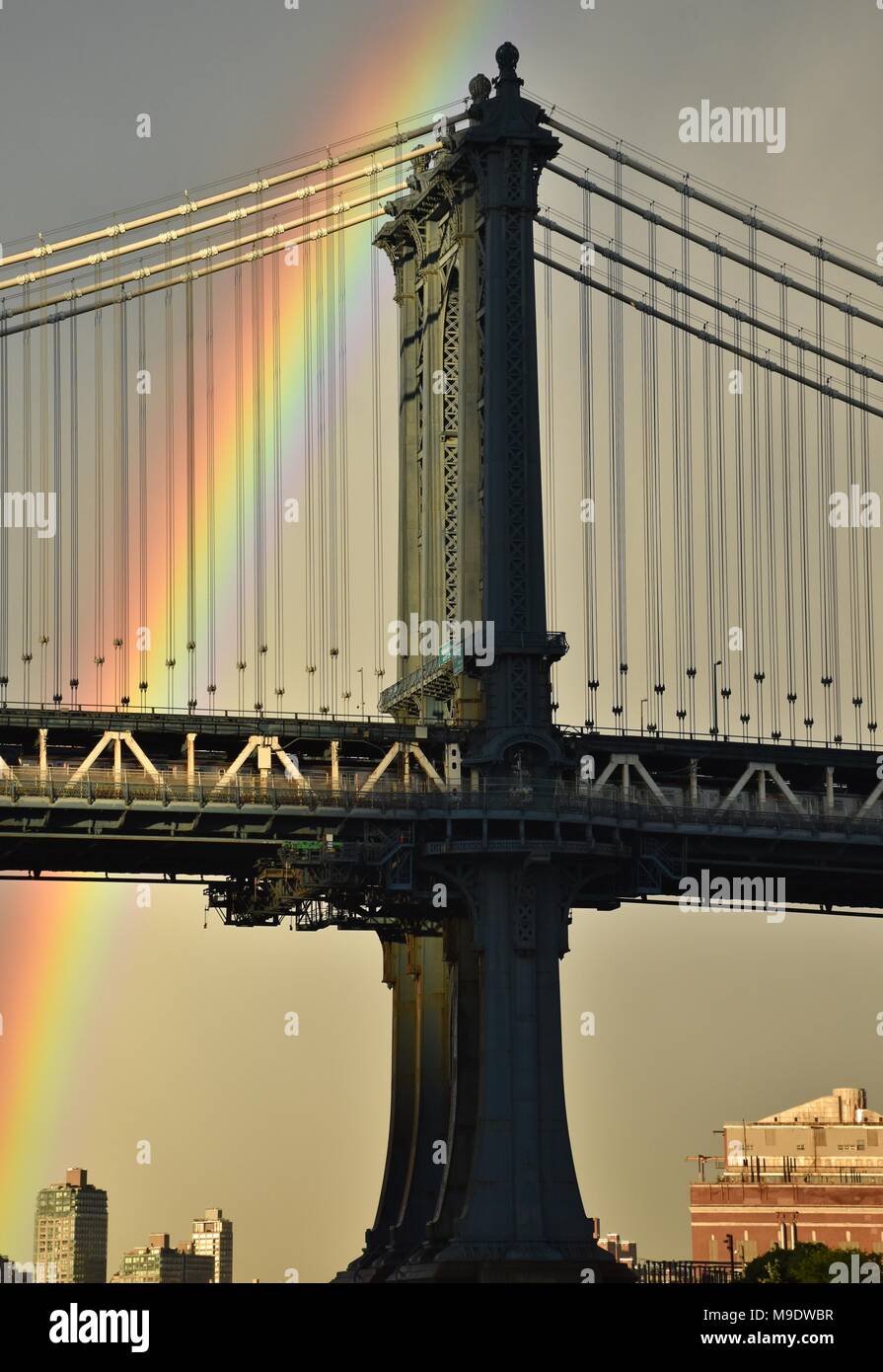 A rainbow behind the Manhattan Bridge in Brooklyn, New York. Stock Photo