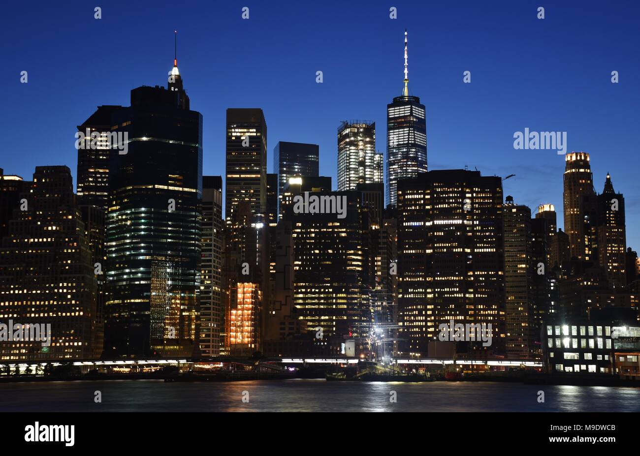 The skyline of downtown Manhattan, the Financial District, and Wall Street from Brooklyn at dusk. Stock Photo