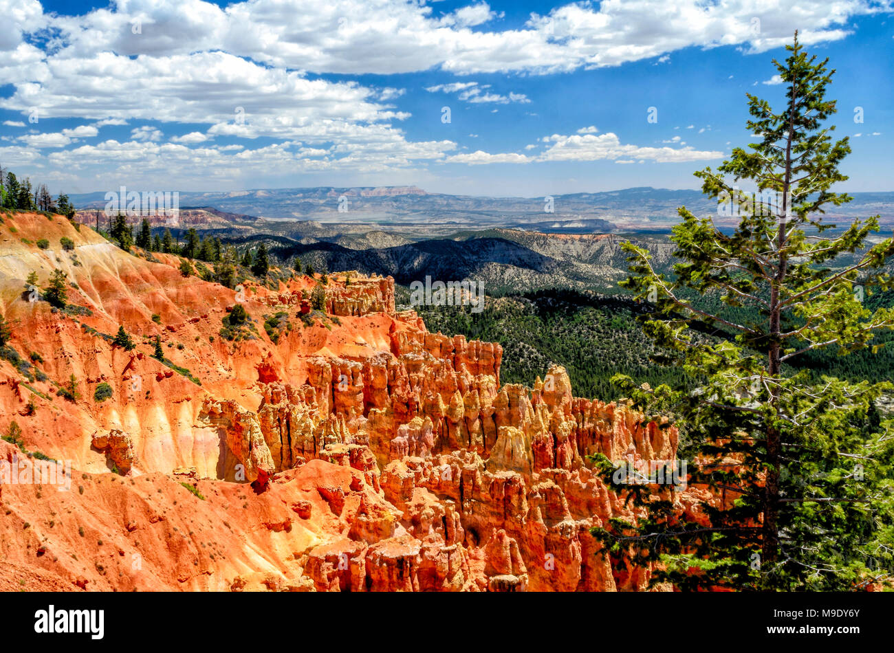 Scenic over look of bright orange sandstone cliffs, mountains and rock